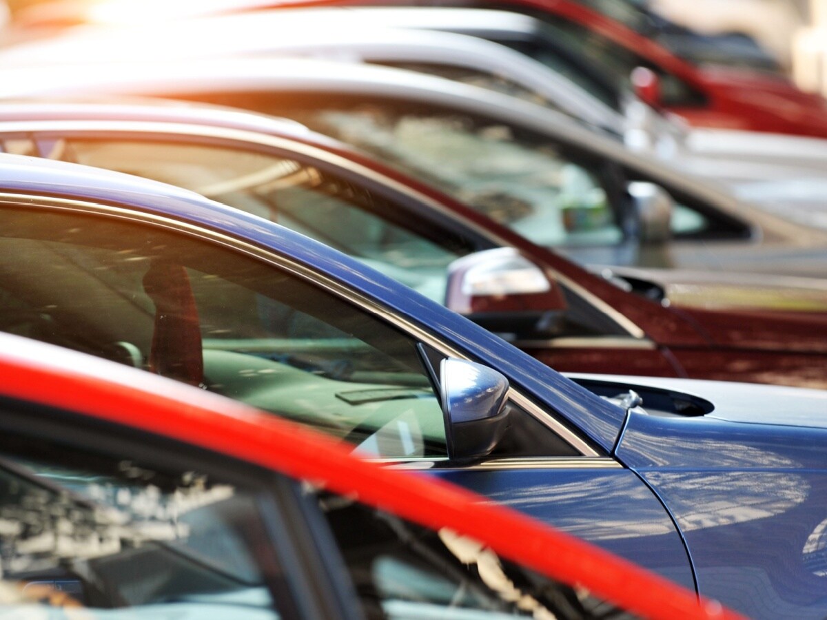 Row of pre-owned vehicles representing used inventory in Metairie