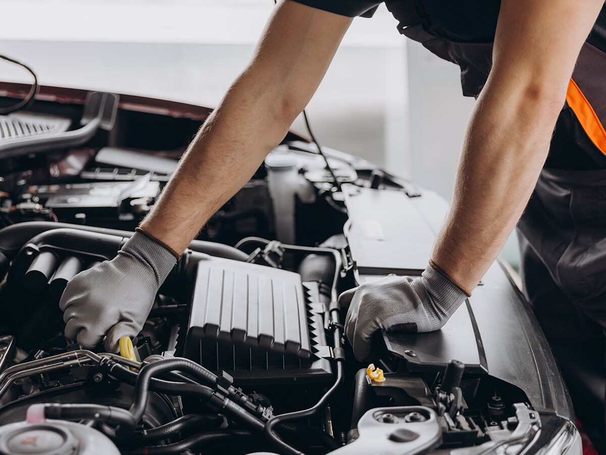 Automotive technician performing vehicle maintenance