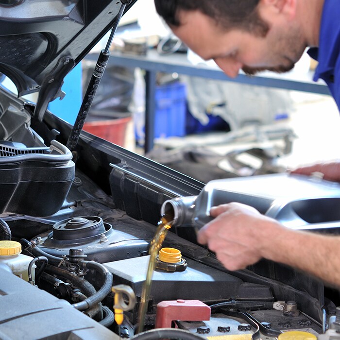 Oil Change Service - Pouring Oil In The Engine