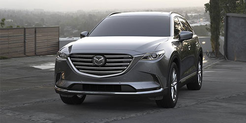 Leasing versus buying a vehicle at Mazda of New Bern in New Bern | Grey mazda parked on a road