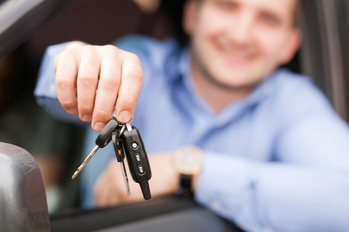 Man_Holding_Keys_Outside_Window.jpg