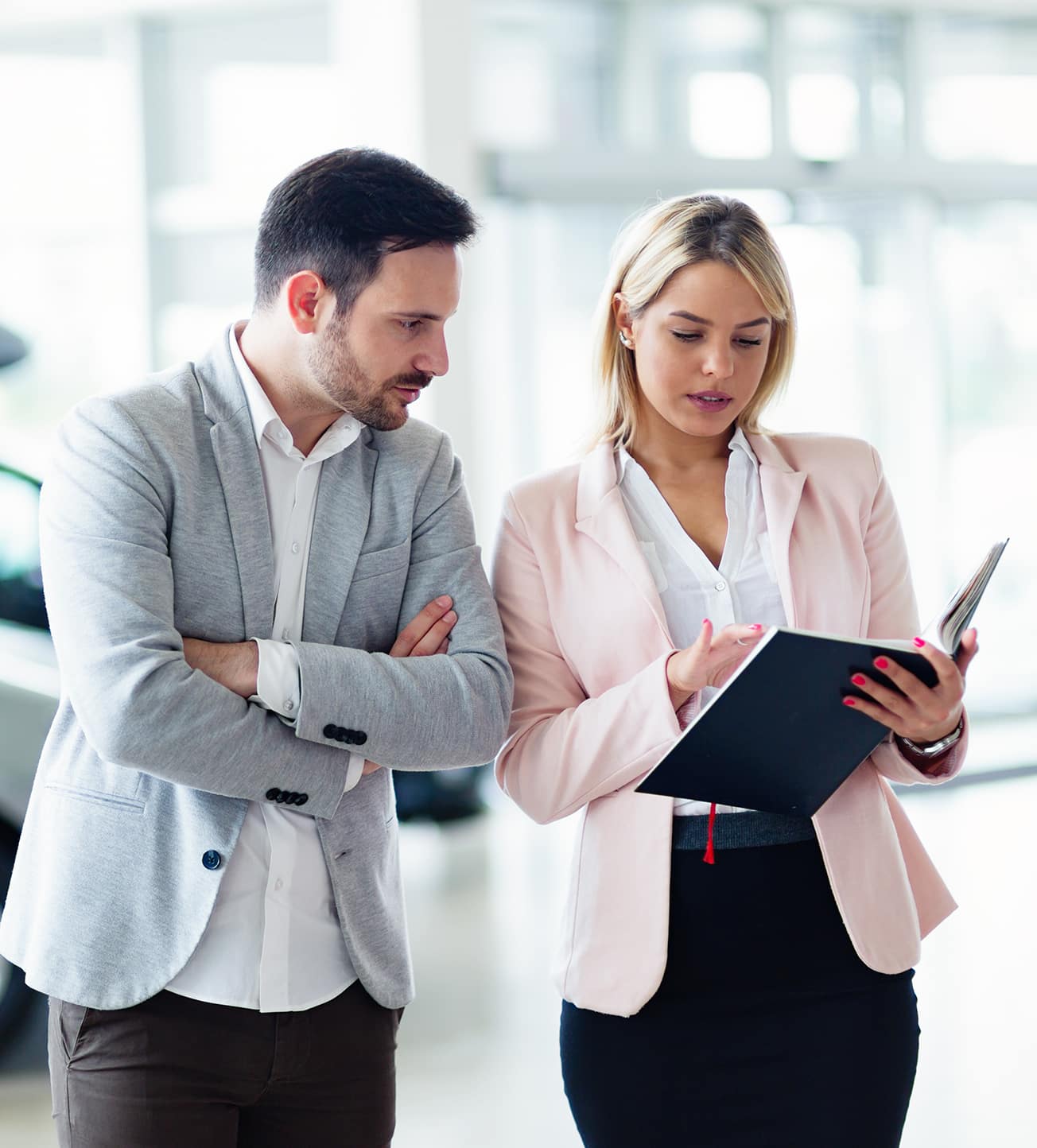 Leasing versus buying a vehicle at Mazda of New Bern in New Bern | Sales agent showing man car information