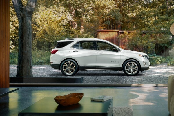2019-Chevrolet-Equinox-Premier-SUV-L06 (1).jpg Chevy Equinox outside a modern home