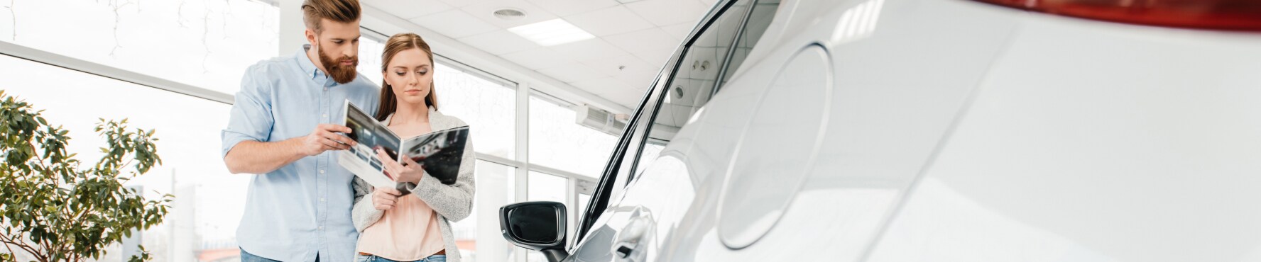 Couple reviewing the brochure for a new Chevrolet car