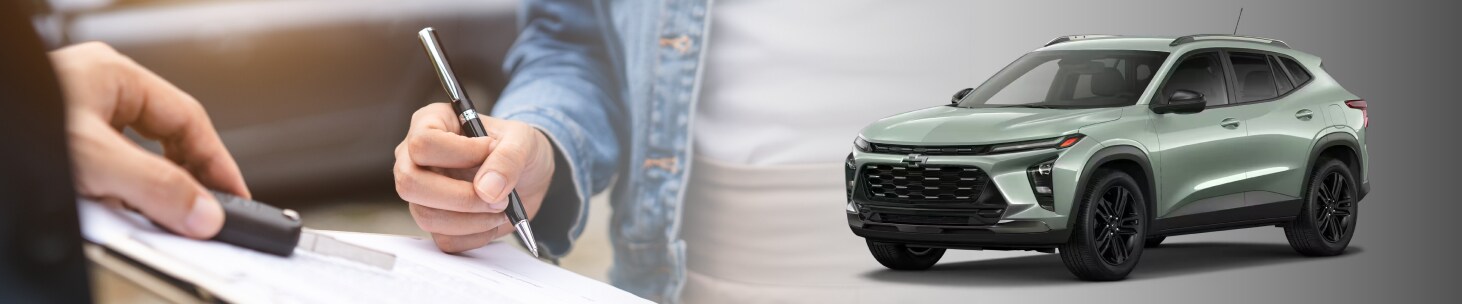 New car paperwork being filled out alongside a 2026 Chevy Trax ACTIV in Cacti Green
