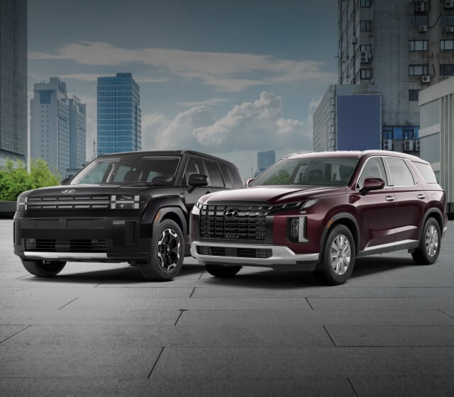 2024 Hyundai Santa Fe SE in Phantom Black and a 2025 Hyundai Palisade SEL AWD in Sierra Burgundy