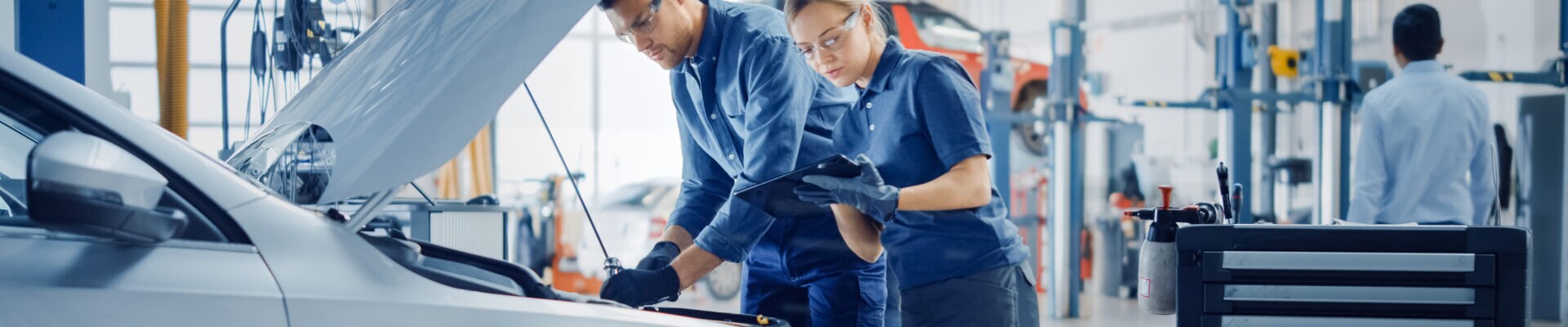 Hyundai service workers inspecting an engine bay