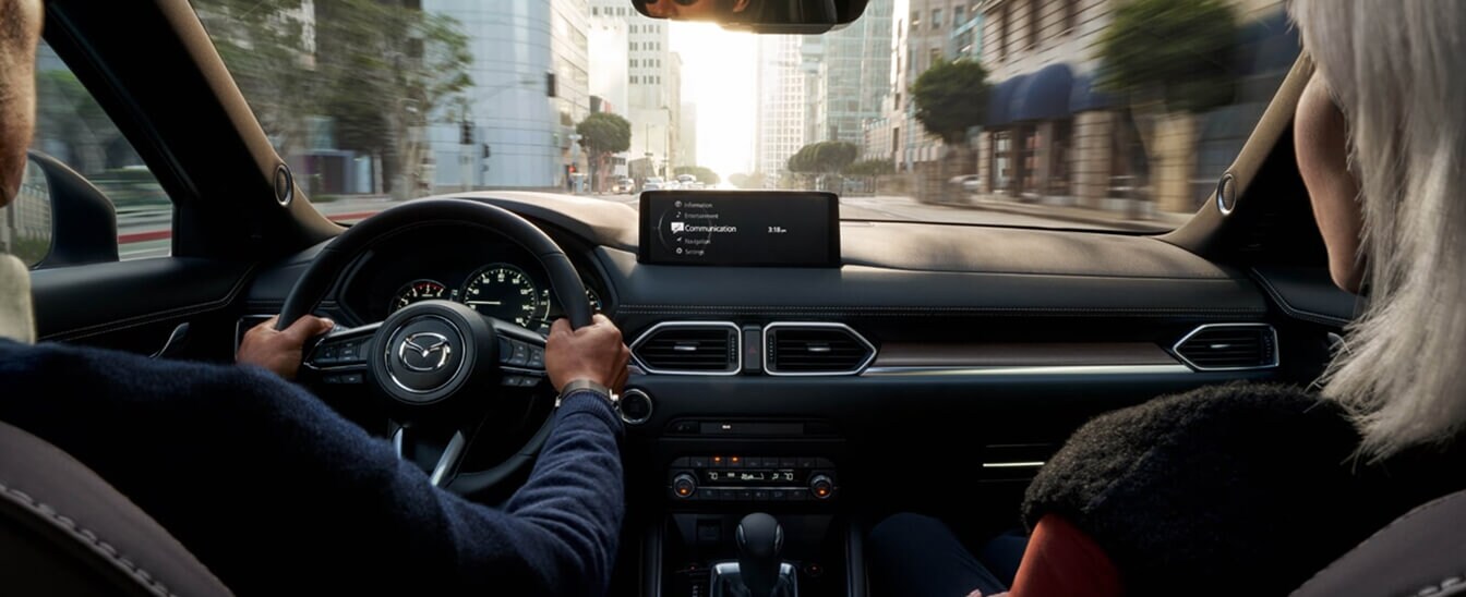 Shot of the front seat of a Mazda CX-5 2.5 Turbo featuring genuine layered wood trim and Caturra Brown Nappa leather-trimmed seats
