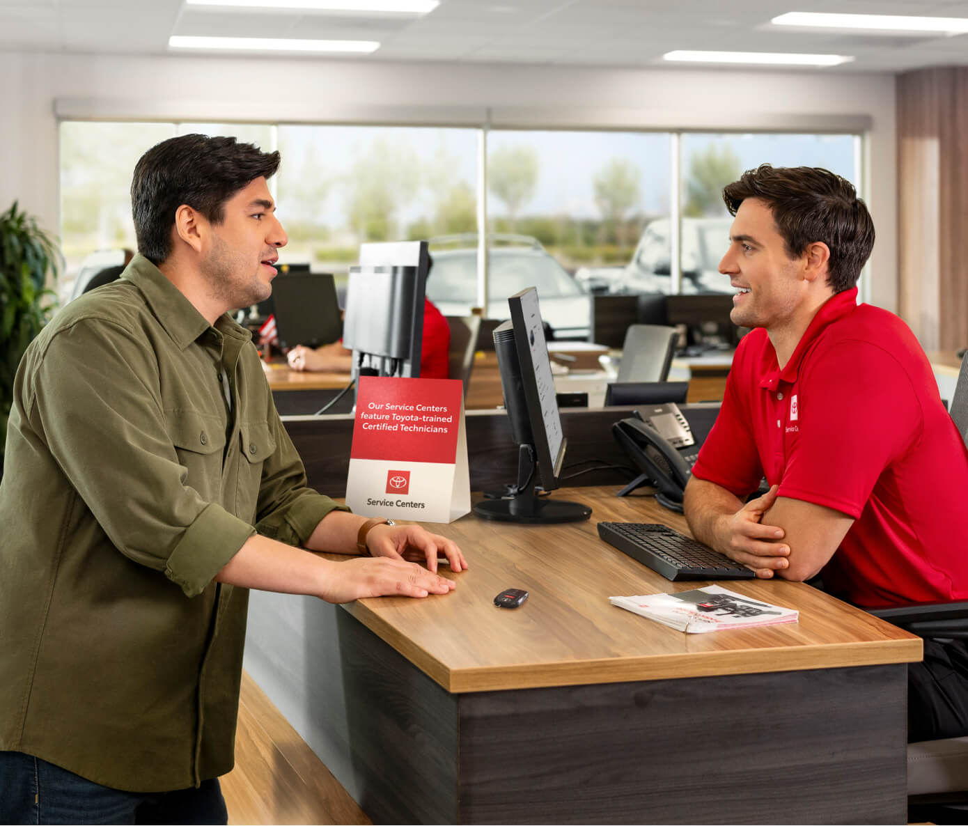 Toyota customer being helped by a Toyota service department employee