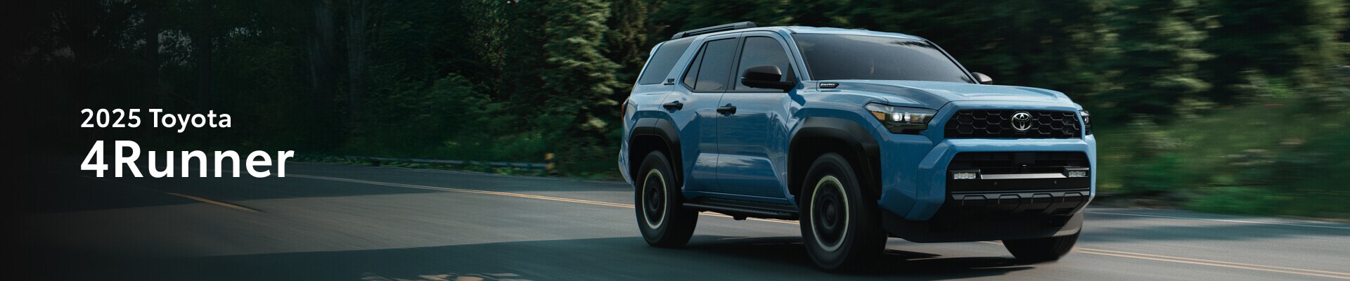 2025 Toyota 4Runner TRD Off-Road in Heritage Blue parked in front of a New Hampshire Forest Landscape