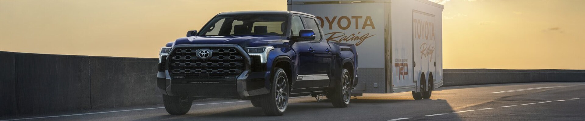 2025 Toyota Tundra Platinum in Blueprint towing a trailer on the highway