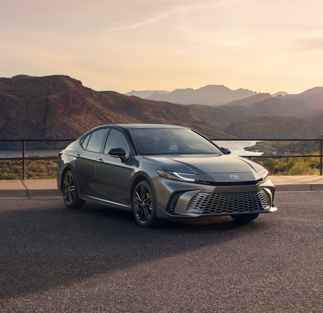 9th generation 2025 Toyota Camry in Heavy Metal parked outdoors in front of a mountainous landscape