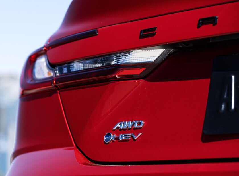 Close-up on the tailgate of a red Toyota Camry AWD showing the taillight and emblem