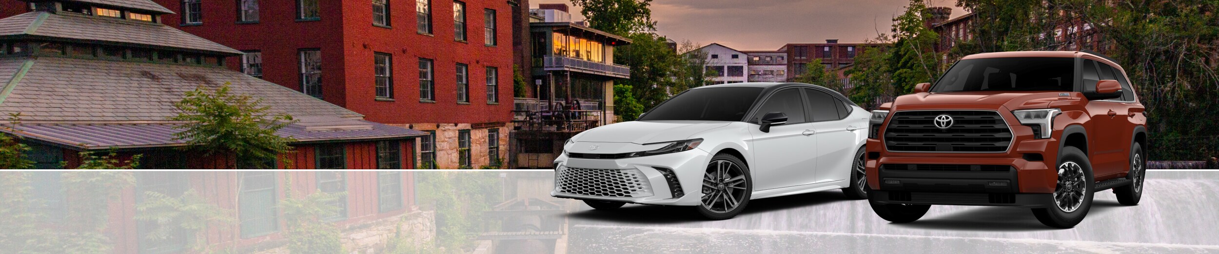 Toyota Avalon Sedan and Toyota Tundra Truck parked in front of an urban background