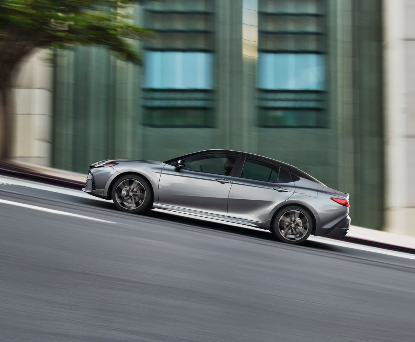 9th Gen Toyota Camry in Celestial Silver Metallic driving uphill