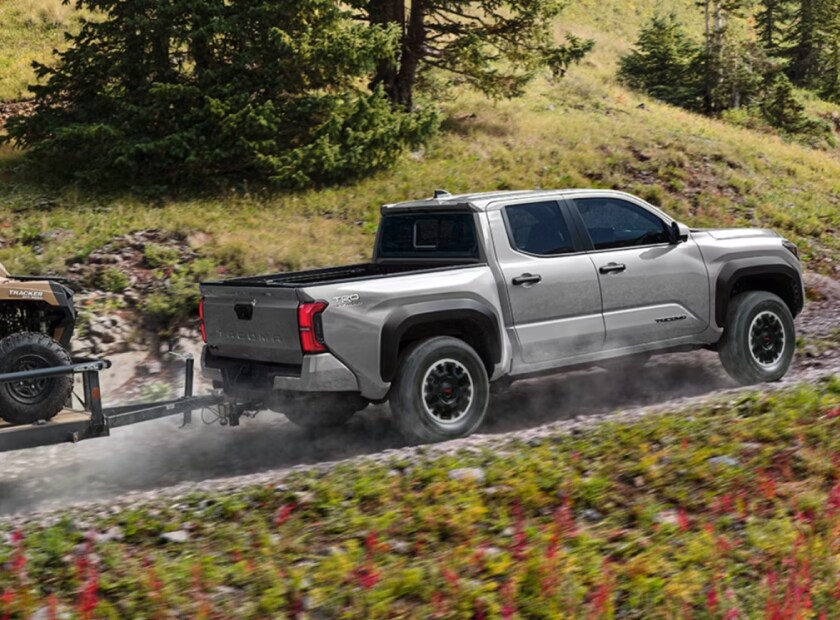 Toyota Tacoma TRD Off-Road towing uphill on a dirt road