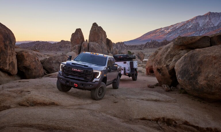2025 GMC Sierra 2500 HD Exterior On Rocks With A Camper