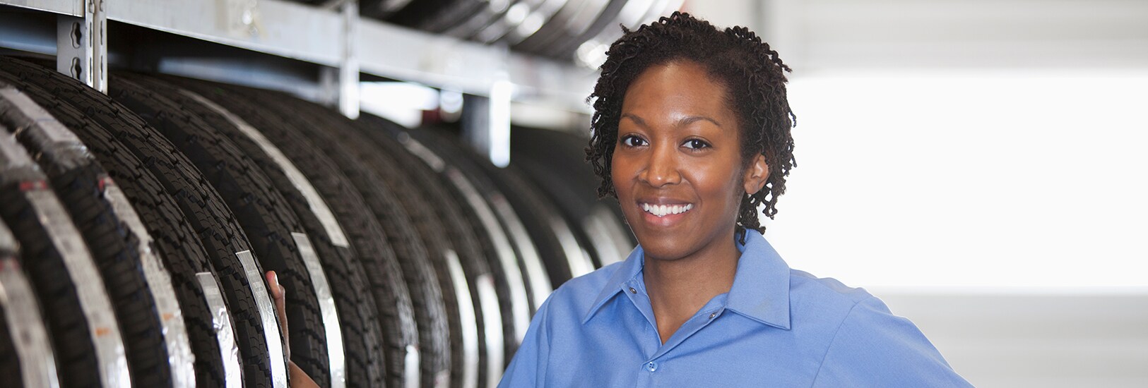 portrait-of-smiling-black-female-mechanic-in-auto-2023-11-27-05-33-19-utc.png
