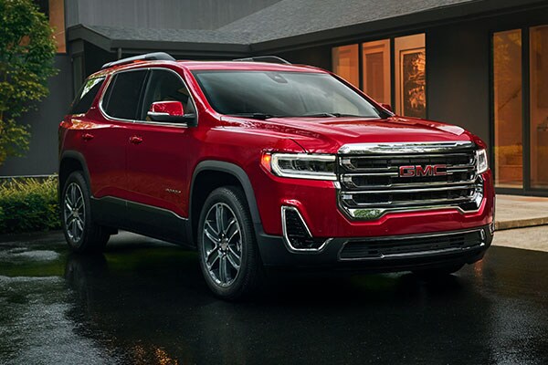 Used GMC Acadia parked next to a house
