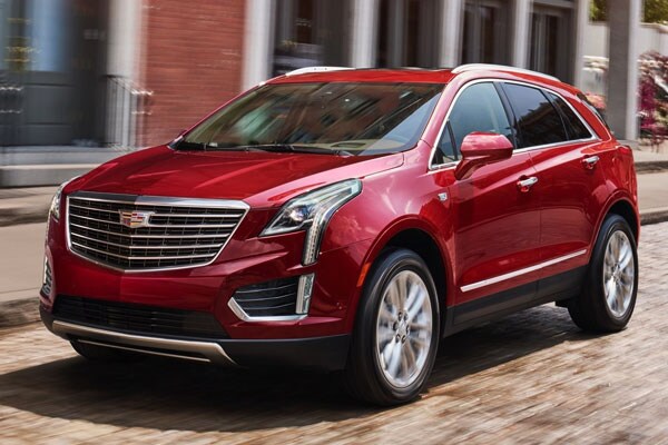 2019 Red Cadillac XT5 driving down suburban road
