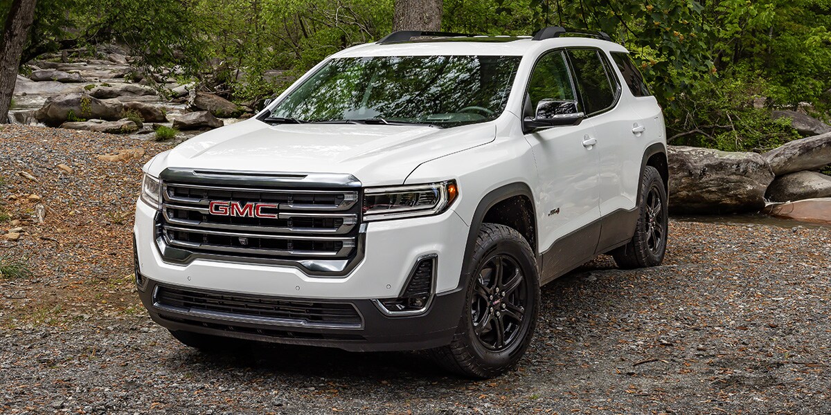 White GMC Acadia Parked in woods