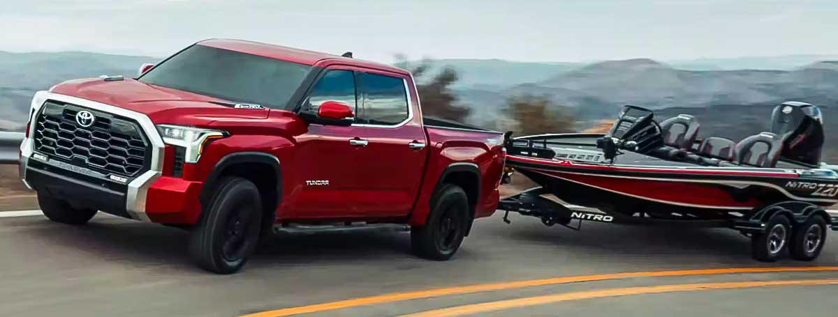 tundras pulling boat on road