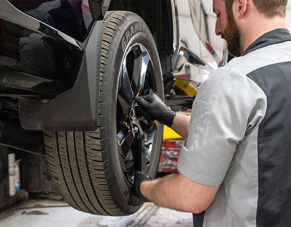 Service tech working on vehicle tire