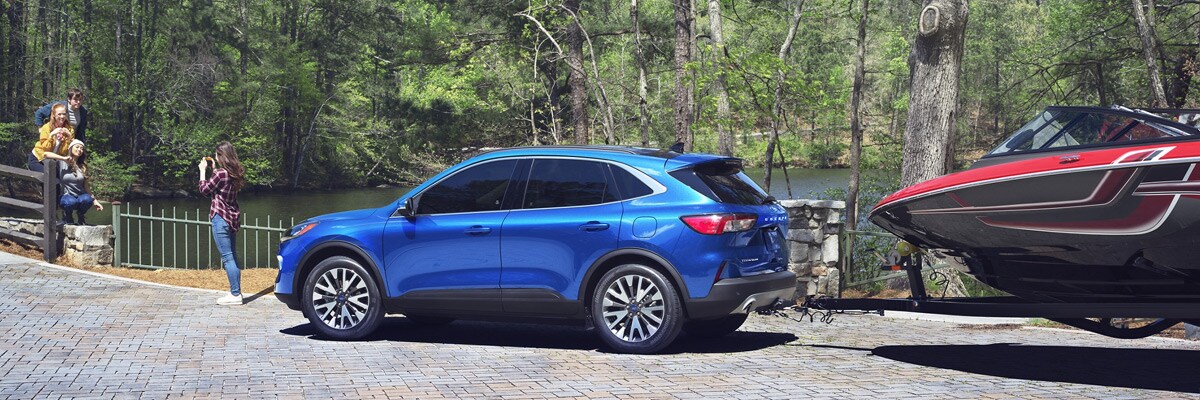 Blue 2021 Ford Escape towing a speedboats