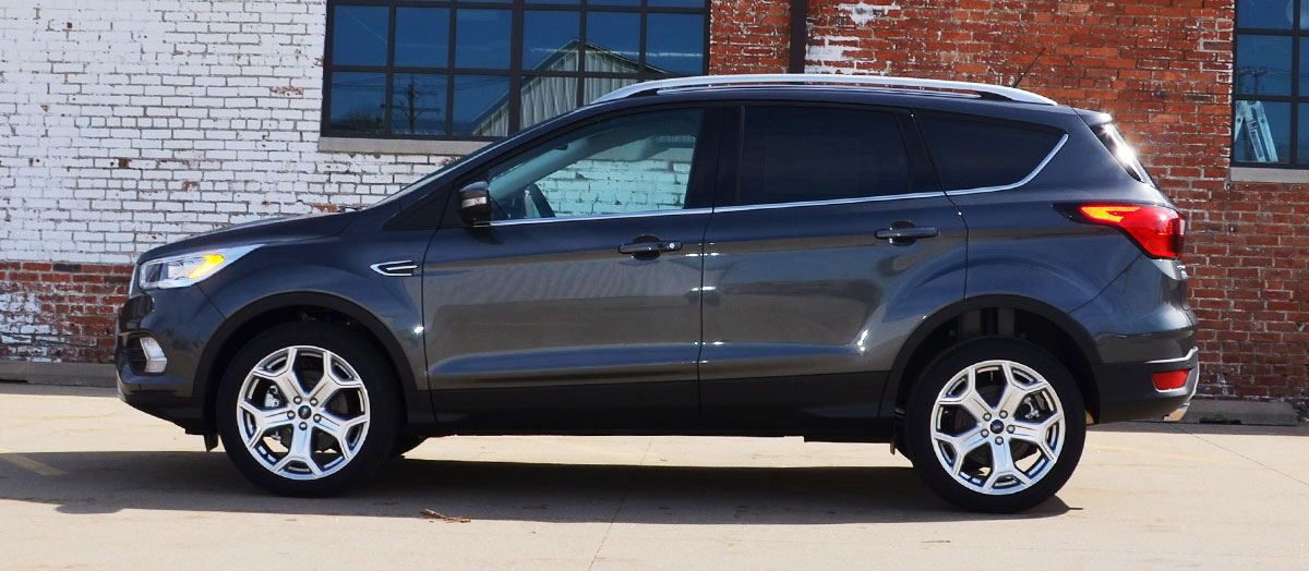 2019 Ford Escape driving in front of a city bridge