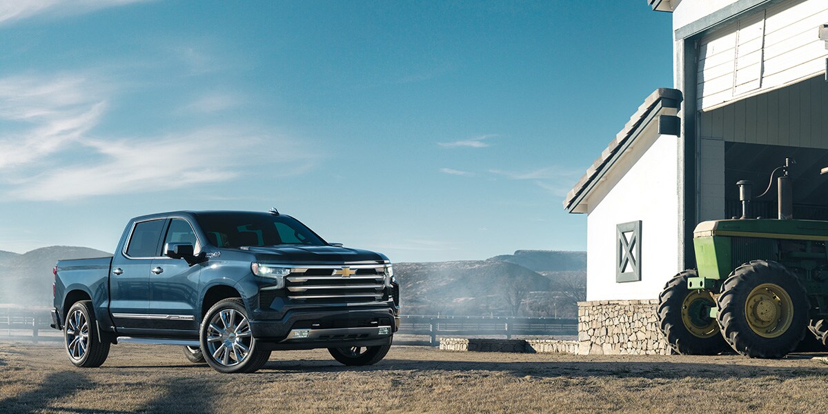 Chevy Silverado 1500 parked on a farm next to a barn