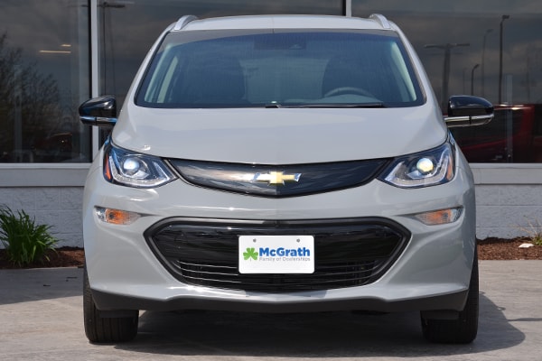 2019 Silver Chevy Bolt parked in front of a buidling