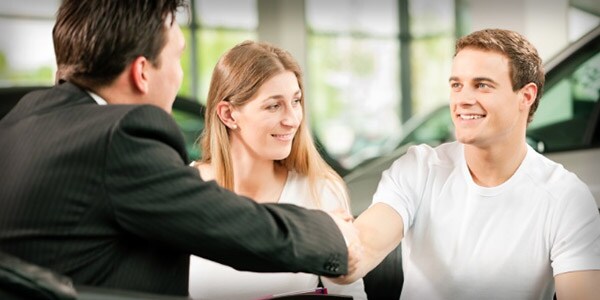 Car salesman shaking hands