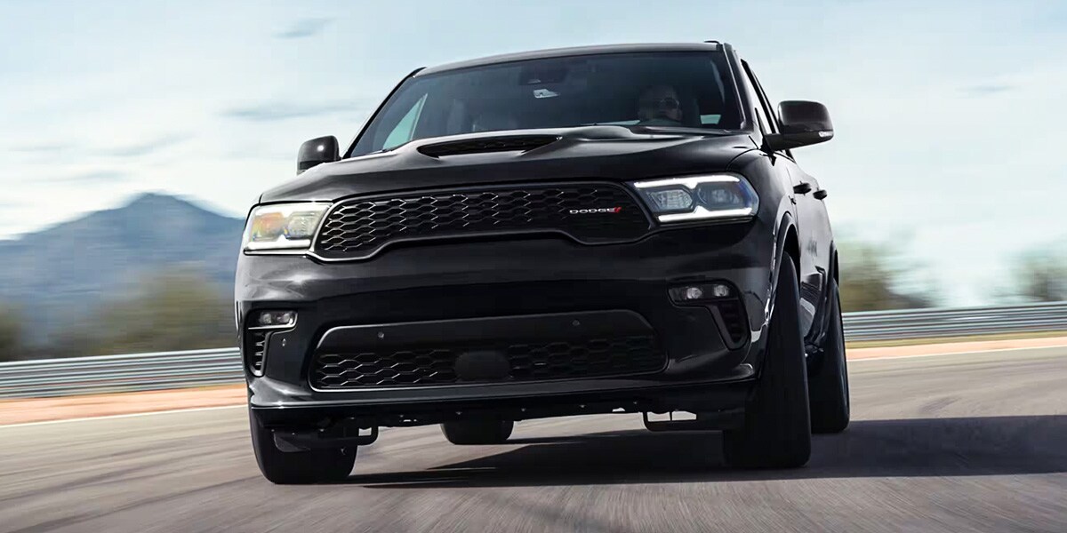 Black Dodge Durango driving down road