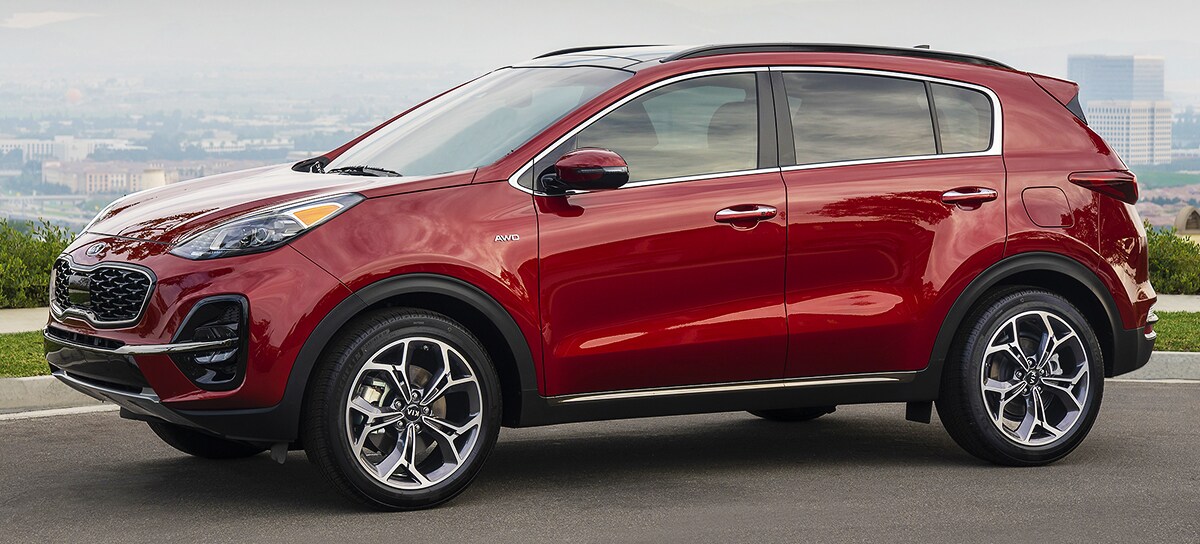 2020 Red Kia Sportage Exterior Parked on a hill top overlooking a city