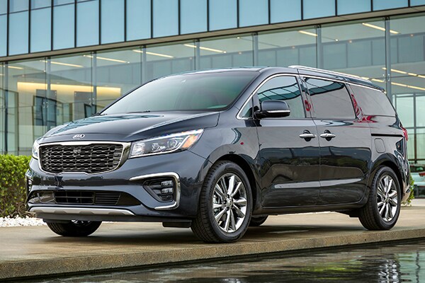 2019 Kia Sedona parked in front of a business building