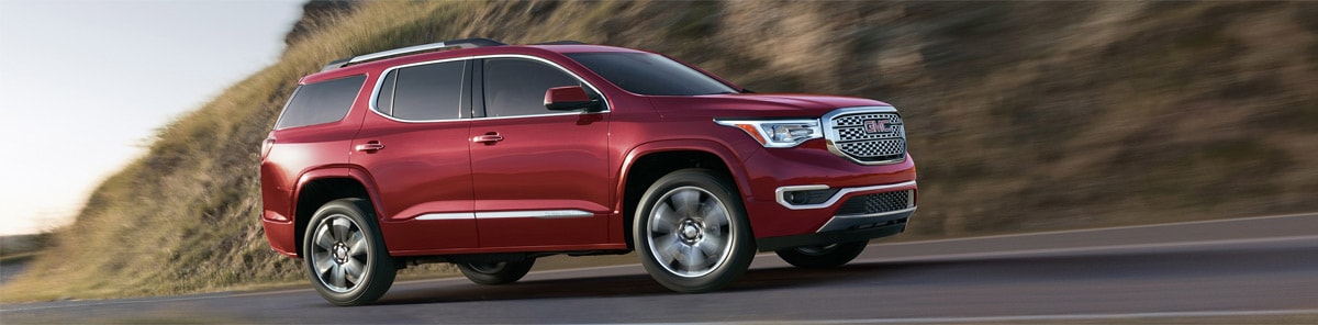 red 2018 acadia passenger side view