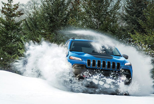 Jeep Cherokee driving through snow
