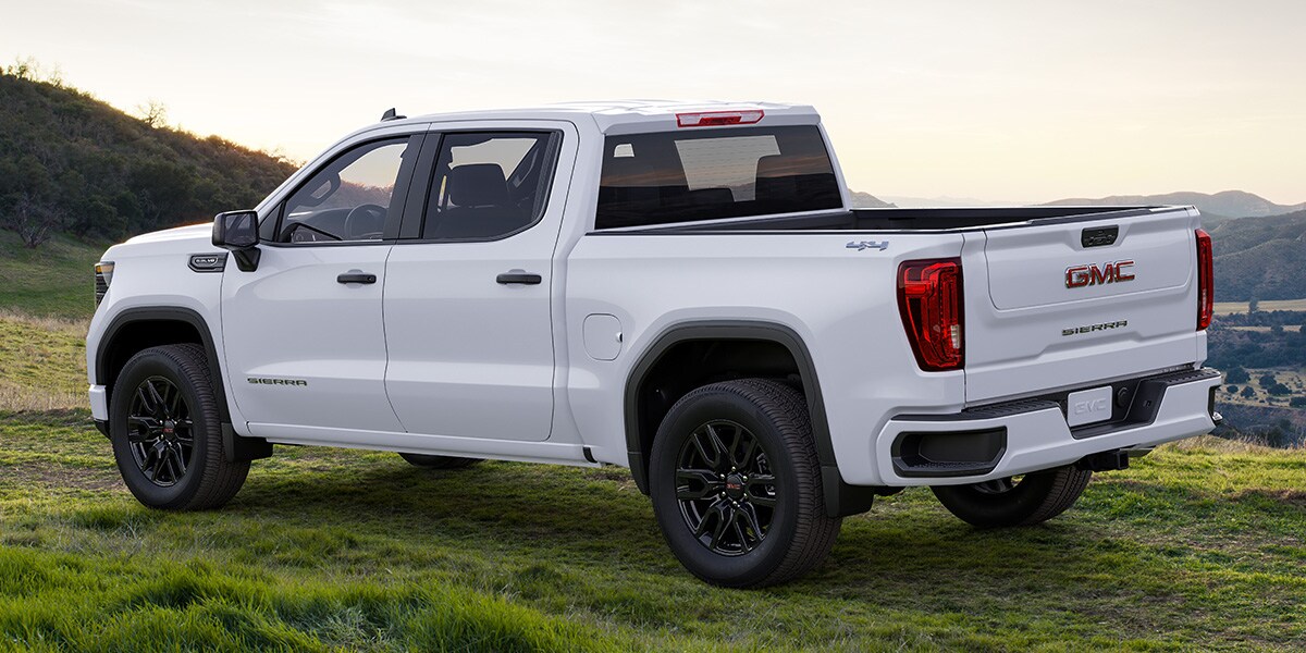 White GMC Pro parked in the grass