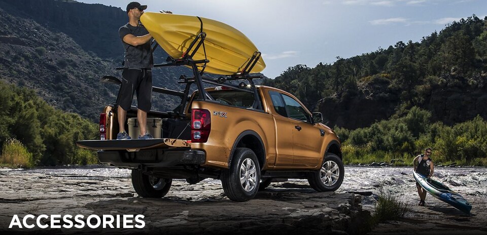 2019 Saber Orange Ford Ranger outfitted with a rack and kayak