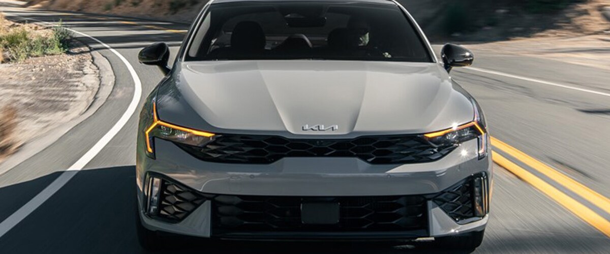 2025 Kia K5 driving down the road