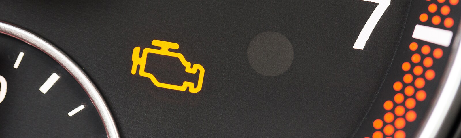 Engine Light photo of a vehicle dashboard with the check engine light on