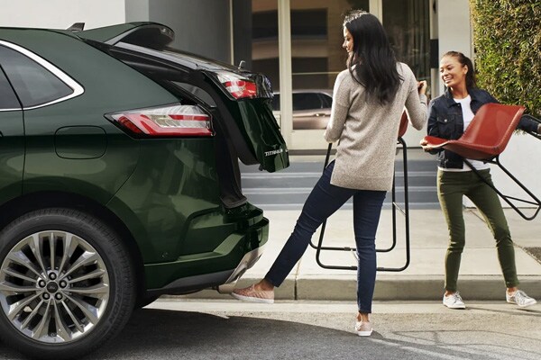 2024 Ford Edge's rear tailgate opening with two people putting in chairs