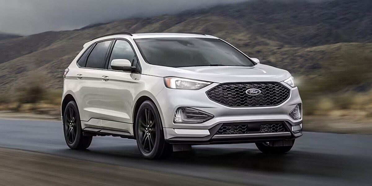 2024 Ford Edge white driving down the road