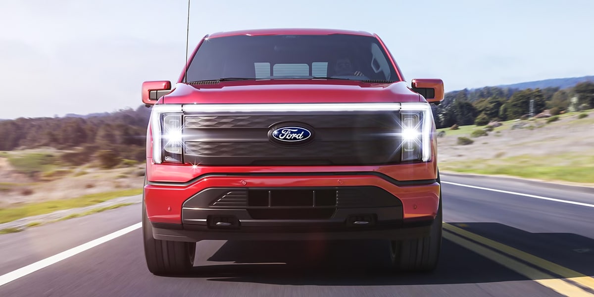 2024 Ford F-150 Lightning driving down the road