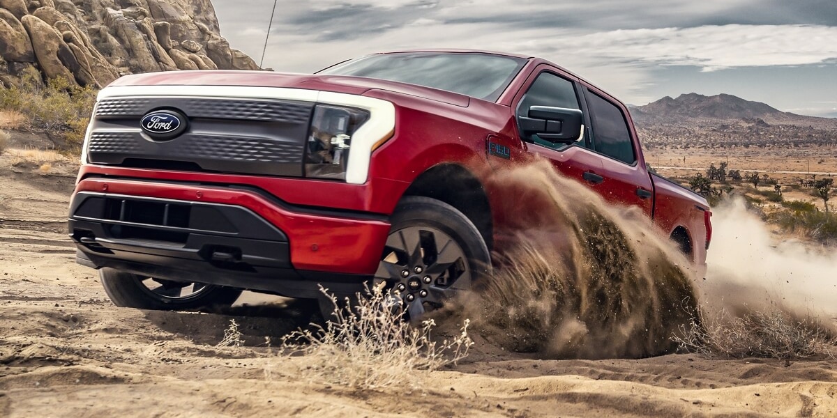 2024 Ford F-150 Lightning driving in the sand