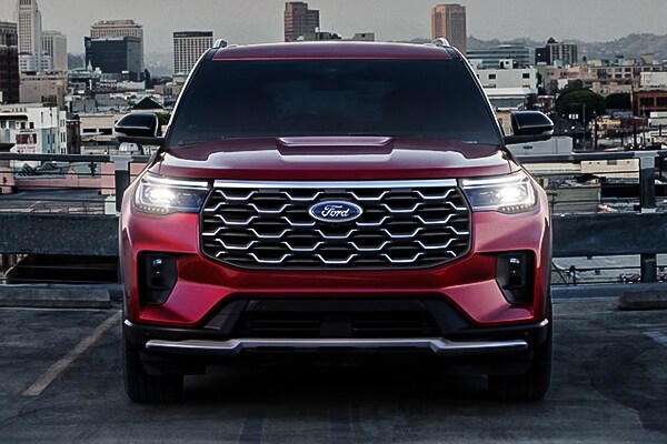 2025 Ford Explorer Front Exterior with lights on with a city scape background