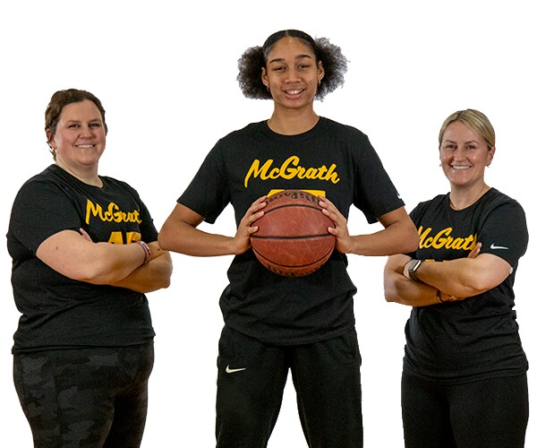 Hannah Stuelke Standing with McGrath Sisters