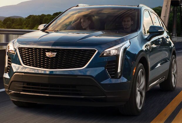 blue 2019 cadillac xt4 driving