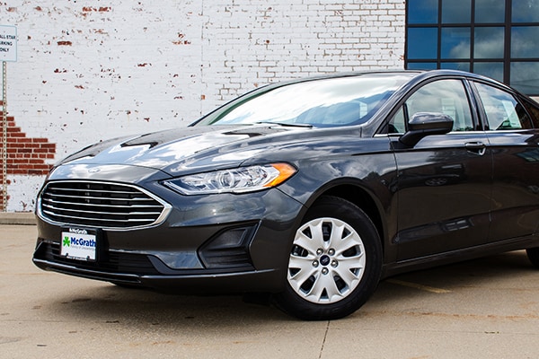 2019 Ford Fusion parked next to a brick wall