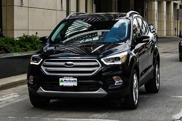 2019 Red Ford Escape driving down a windy road